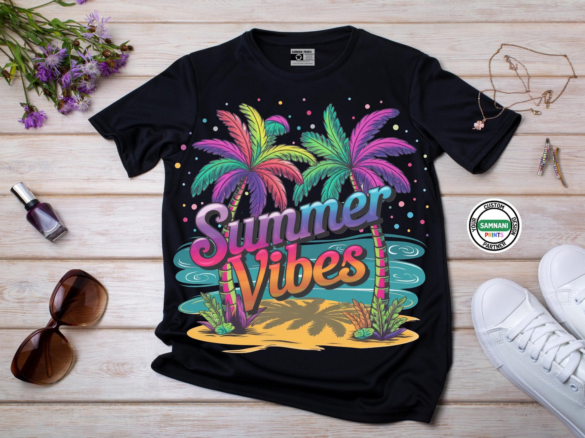 A flat lay black t -shirt with a colorful “Summer Vibes” design featuring neon palm trees, waves, and a tropical island background sitting in front of a neutral background. Styled with white shoes, sunglasses, nailpolish, and flowers. Summer Vibes T-shirt, summer outfit, gift for her, bachelorette matching shirts, birthday gift, gift for birthday, cruise t-shirt, family cruise matching t-shirts, matching family t-shirts, gift for him, gift for mom, mother&#39;s day gift, gift for mother.